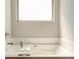 Relaxing bathtub featuring a window, soaking space, and a clean, modern design at 64 Citadel Dr, Hampton, GA 30228