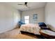 Comfortable carpeted bedroom with a ceiling fan, cozy armchair, and a window for natural light at 64 Citadel Dr, Hampton, GA 30228