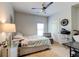 Bright bedroom features a ceiling fan and neutral walls, providing a calm and inviting space at 64 Citadel Dr, Hampton, GA 30228