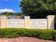 Elegant community sign for Colonial Gardens and The Villages at Liberty Square Park, nestled amongst lush greenery at 64 Citadel Dr, Hampton, GA 30228