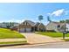 Inviting exterior view of a well-manicured home with a two-car garage and lush landscaping at 64 Citadel Dr, Hampton, GA 30228