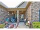 Inviting front porch adorned with seating, potted plants, and decorative accents at 64 Citadel Dr, Hampton, GA 30228