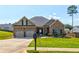 Charming brick home with a well-manicured front yard, two-car garage, and inviting curb appeal at 64 Citadel Dr, Hampton, GA 30228