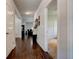 Spacious hallway with dark wood floors, neutral walls and decorative wall decor at 64 Citadel Dr, Hampton, GA 30228