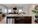 Spacious kitchen island features a stainless steel dishwasher and ample room for seating at 64 Citadel Dr, Hampton, GA 30228