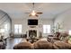 Comfortable living room features a ceiling fan, fireplace, and a plush, oversized leather sofa at 64 Citadel Dr, Hampton, GA 30228