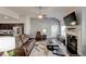 Comfortable living room boasts plush seating, fireplace, and decorative wall with vaulted ceiling at 64 Citadel Dr, Hampton, GA 30228