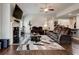 Comfortable living room features a ceiling fan, fireplace, and a plush, oversized leather sofa at 64 Citadel Dr, Hampton, GA 30228