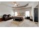 Spacious main bedroom boasts a sitting area, tray ceilings, and plush carpeting at 64 Citadel Dr, Hampton, GA 30228