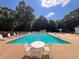 Community pool with plenty of lounge chairs, tables and chairs, ready for summertime fun at 64 Citadel Dr, Hampton, GA 30228