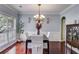 Formal dining room featuring elegant lighting, hardwood floors, and classic decor for sophisticated dining at 7115 Secret Rose, Douglasville, GA 30134