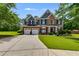 Charming two-story home with a well-manicured lawn and a spacious driveway leading to a two-car garage at 7115 Secret Rose, Douglasville, GA 30134