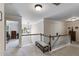 Upstairs hallway featuring neutral walls, modern lighting, and a view to the living area below at 7115 Secret Rose, Douglasville, GA 30134