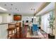 Open-concept kitchen flowing into a dining area, featuring a breakfast bar and modern lighting at 7115 Secret Rose, Douglasville, GA 30134