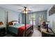 Comfortable main bedroom with a four-poster bed, neutral walls, ceiling fan, and lots of natural light at 7115 Secret Rose, Douglasville, GA 30134