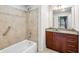 Bathroom featuring granite countertops, single sink vanity, shower, and tub at 1261 Caroline Se St # 108, Atlanta, GA 30307