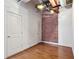 Bedroom featuring hardwood flooring, an exposed brick wall, and closet space at 1261 Caroline Se St # 108, Atlanta, GA 30307