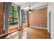 Spacious bedroom with large windows, exposed brick wall, and hardwood flooring at 1261 Caroline Se St # 108, Atlanta, GA 30307