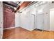 Stylish bedroom with hardwood flooring, exposed brick, and modern lighting at 1261 Caroline Se St # 108, Atlanta, GA 30307