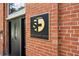 Close-up of the Shoe Factory Lofts entrance with brick facade and detailed signage at 1261 Caroline Se St # 108, Atlanta, GA 30307