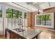 Open kitchen with granite counters, stainless appliances, island and exposed brick at 1261 Caroline Se St # 108, Atlanta, GA 30307