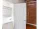 Laundry room with stackable washer and dryer and brick accent wall at 1261 Caroline Se St # 108, Atlanta, GA 30307