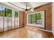 Open living space with hardwood floors, exposed brick wall and large windows at 1261 Caroline Se St # 108, Atlanta, GA 30307