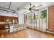 Open living space featuring exposed brick, kitchen with modern appliances, high ceilings, and natural light at 1261 Caroline Se St # 108, Atlanta, GA 30307