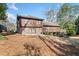 Spacious backyard featuring a large wooden deck, patio, and lush lawn with trees, perfect for outdoor entertaining at 1905 Castleway Ne Ln, Atlanta, GA 30345