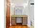 Bathroom with vanity and cabinets, complete with mirror, lighting fixtures, toilet, and doorway at 1905 Castleway Ne Ln, Atlanta, GA 30345