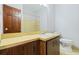 Bathroom featuring a single vanity with a large mirror, and a bathtub with tile walls at 1905 Castleway Ne Ln, Atlanta, GA 30345
