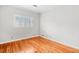 Comfortable bedroom featuring hardwood floors and a window with plantation shutters at 1905 Castleway Ne Ln, Atlanta, GA 30345