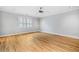 A bright and airy bedroom featuring hardwood floors, neutral paint, and a ceiling fan at 1905 Castleway Ne Ln, Atlanta, GA 30345