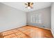 Bright bedroom featuring beautiful hardwood floors, a ceiling fan, and a large window with plantation shutters at 1905 Castleway Ne Ln, Atlanta, GA 30345