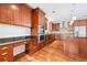 Spacious kitchen features cherry cabinets, granite countertops, stainless steel appliances, and breakfast bar at 1905 Castleway Ne Ln, Atlanta, GA 30345