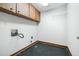 A utilitarian laundry room featuring basic cabinets, utility connections, and a simple design at 1905 Castleway Ne Ln, Atlanta, GA 30345