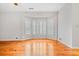 Light-filled living room featuring hardwood floors and a bay window with plantation shutters at 1905 Castleway Ne Ln, Atlanta, GA 30345