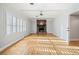 Cozy living room features a brick fireplace, hardwood floors, and neutral paint at 1905 Castleway Ne Ln, Atlanta, GA 30345