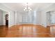 Bright living room with hardwood floors, crown molding, bay window, and shuttered windows at 1905 Castleway Ne Ln, Atlanta, GA 30345