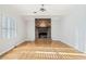 Bright living room features a brick fireplace, hardwood floors, and neutral paint at 1905 Castleway Ne Ln, Atlanta, GA 30345