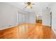 Spacious living room with hardwood floors, a ceiling fan, and large windows, providing ample natural light at 1905 Castleway Ne Ln, Atlanta, GA 30345
