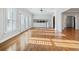 Sunlit living room featuring hardwood floors, white trim, and french doors to outside at 1905 Castleway Ne Ln, Atlanta, GA 30345