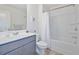 Clean bathroom featuring a tub and shower combination, a gray vanity and a neutral color palette at 2711 Kemp Ct, Conyers, GA 30094