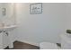 Modern half-bathroom featuring a pedestal sink, white trim, neutral walls and a hardwood floor at 2711 Kemp Ct, Conyers, GA 30094