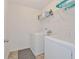 Functional laundry room with washer, dryer, storage shelves, and a practical layout for efficient chores at 2711 Kemp Ct, Conyers, GA 30094