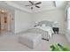 Spacious main bedroom featuring a tray ceiling, plush carpeting, a large bed, and ample natural light at 2711 Kemp Ct, Conyers, GA 30094