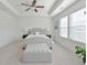 Serene main bedroom featuring a tray ceiling, plush carpeting, a large bed, and ample natural light at 2711 Kemp Ct, Conyers, GA 30094