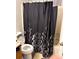 Compact bathroom featuring a floral shower curtain, toilet, and tiled flooring for easy maintenance at 3464 Kingswood Trl, Decatur, GA 30034