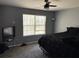 Relaxing bedroom with plush carpet, ceiling fan, and a bright window for natural light at 3464 Kingswood Trl, Decatur, GA 30034
