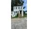 Two-story home featuring neutral siding, complementary black shutters, and wooden stairway up to covered front entry at 3464 Kingswood Trl, Decatur, GA 30034